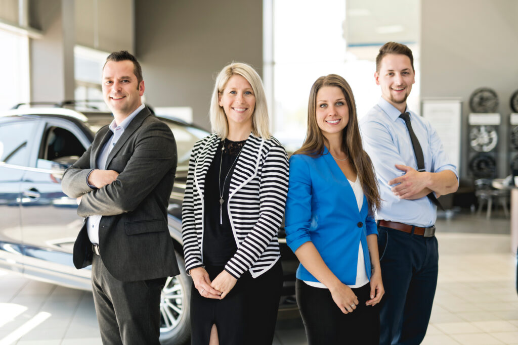 Boost Employee Retention - group of happy dealership employees